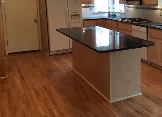 Modern kitchen featuring newly replaced laminate flooring in Kansas City, MO.